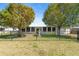 Charming home with a fenced front yard, mature shade trees, and a decorative water fountain at 2255 Easy St, Port Charlotte, FL 33952