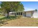Charming single-story home with a spacious yard, mature tree, and enclosed sunroom at 2255 Easy St, Port Charlotte, FL 33952