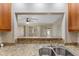 A view of the living room is visible from the kitchen over the granite countertop at 2255 Easy St, Port Charlotte, FL 33952