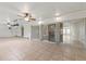 Large sunroom with tiled flooring, ceiling fans, and expansive sliding glass doors for seamless indoor-outdoor living at 2255 Easy St, Port Charlotte, FL 33952