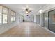 This sunroom has tile floors, three ceiling fans, and sliding glass doors for natural light at 2255 Easy St, Port Charlotte, FL 33952