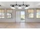This sunroom features tile floors, lighting, and windows offering outdoor views at 2255 Easy St, Port Charlotte, FL 33952