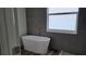 Elegant bathroom with freestanding tub, tile surround, and frosted window at 23490 Macbeth Ct, Punta Gorda, FL 33980