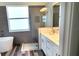Bathroom with gray tile, glass shower, and soaking tub at 23490 Macbeth Ct, Punta Gorda, FL 33980
