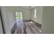 Spacious bedroom with luxury vinyl floors and sliding glass doors to the backyard at 23490 Macbeth Ct, Punta Gorda, FL 33980
