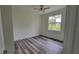 Bright bedroom features a ceiling fan, window with natural light, and wood-look flooring at 23490 Macbeth Ct, Punta Gorda, FL 33980