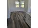A cozy dining area with wood-style flooring, bright natural light, and modern lighting at 23490 Macbeth Ct, Punta Gorda, FL 33980