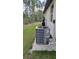 Exterior shot showing the air conditioning unit and water filtration system at 23490 Macbeth Ct, Punta Gorda, FL 33980
