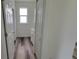 Hallway with wood-look flooring leads past a vanity and linen closet at 23490 Macbeth Ct, Punta Gorda, FL 33980