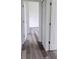 Hallway with doors leading to various rooms with wood-look flooring at 23490 Macbeth Ct, Punta Gorda, FL 33980