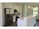 Bright kitchen featuring stainless steel appliances, white cabinets, and eat-in peninsula at 23490 Macbeth Ct, Punta Gorda, FL 33980