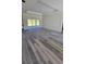 A spacious living room featuring modern wood floors and sliding glass doors to a backyard patio at 23490 Macbeth Ct, Punta Gorda, FL 33980