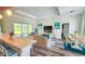 Staged living room with tray ceiling and sliding glass doors to the outside at 23490 Macbeth Ct, Punta Gorda, FL 33980