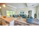 Staged living room with tray ceiling and sliding glass doors to the lanai at 23490 Macbeth Ct, Punta Gorda, FL 33980