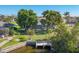 Aerial view of a residence with mature trees, manicured lawn, and dock in a waterfront community at 2501 Rio Grande Dr, Punta Gorda, FL 33950