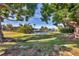 Manicured lawn and trees extend to the waterfront, offering a serene backyard view of the canal at 2501 Rio Grande Dr, Punta Gorda, FL 33950
