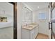 Bright bathroom featuring double vanity, backlit mirror, and modern finishes at 2501 Rio Grande Dr, Punta Gorda, FL 33950