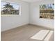Light-filled bedroom with large windows offering views of palm trees at 2501 Rio Grande Dr, Punta Gorda, FL 33950
