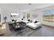 Bright living room featuring a plush sectional sofa, stylish decor, and large windows at 2501 Rio Grande Dr, Punta Gorda, FL 33950