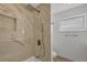 Newly remodeled shower featuring rain shower head, handheld wand, and marble-style tiling at 2501 Rio Grande Dr, Punta Gorda, FL 33950