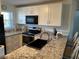 Bright kitchen features granite counters, stainless steel appliances, and sleek black hardware at 25100 Sandhill Blvd # I201, Punta Gorda, FL 33983