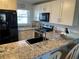 Bright kitchen features granite counters, stainless steel appliances, and sleek black hardware at 25100 Sandhill Blvd # I201, Punta Gorda, FL 33983