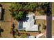 Aerial view of property with a large screened-in pool, spacious backyard, and mature landscaping at 2550 Ivanhoe St, Port Charlotte, FL 33952