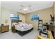 Cozy bedroom with a bed, and natural light from two windows, creating a serene and comfortable space at 2550 Ivanhoe St, Port Charlotte, FL 33952
