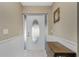 Warm entryway featuring a decorative glass front door, tiled floor, wainscotting and a wooden table at 2550 Ivanhoe St, Port Charlotte, FL 33952
