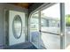 Inviting entryway featuring a decorative glass front door, tiled floor, and a covered porch area at 2550 Ivanhoe St, Port Charlotte, FL 33952