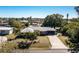 The front of the home showing the landscaped lawn and a long driveway at 2550 Ivanhoe St, Port Charlotte, FL 33952