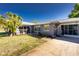 Charming single story home with well-maintained lawn, complemented by a mature palm tree in the front yard at 2550 Ivanhoe St, Port Charlotte, FL 33952