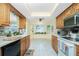 Bright kitchen featuring light oak cabinetry, white countertops, and a bay window over the sink area at 2550 Ivanhoe St, Port Charlotte, FL 33952