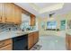 Well-maintained kitchen offers wooden cabinets and a pass-through to the sunroom at 2550 Ivanhoe St, Port Charlotte, FL 33952