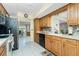 Well-lit kitchen boasting wooden cabinets, black appliances, and tile backsplash at 2550 Ivanhoe St, Port Charlotte, FL 33952