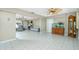 Spacious living room with neutral tile flooring, ceiling fans, and an aquarium for a cozy atmosphere at 2550 Ivanhoe St, Port Charlotte, FL 33952