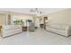 Bright and airy living room with neutral walls, tile flooring, comfortable seating, and natural light at 2550 Ivanhoe St, Port Charlotte, FL 33952