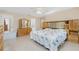 Bright main bedroom with large bed, dresser, and mirror, filled with natural light from windows and ample storage at 2550 Ivanhoe St, Port Charlotte, FL 33952