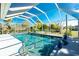 A sparkling pool surrounded by a screened enclosure, offering a private oasis for relaxation and recreation at 2550 Ivanhoe St, Port Charlotte, FL 33952