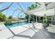 Screened pool area with a covered patio and a blue swimming pool that is ready for entertaining at 2550 Ivanhoe St, Port Charlotte, FL 33952