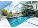 Inviting screened pool area with a turquoise pool, perfect for relaxing and enjoying the outdoors at 2550 Ivanhoe St, Port Charlotte, FL 33952