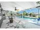 Bright sunroom with a ceiling fan that features a sparkling outdoor pool, inviting relaxation and enjoyment at 2550 Ivanhoe St, Port Charlotte, FL 33952
