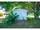 Outdoor shed surrounded by tropical plants and lush greenery, providing ample storage and a serene setting at 2550 Ivanhoe St, Port Charlotte, FL 33952