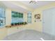 Bright sunroom filled with natural light boasts tile floors and large windows with a plant shelf at 2550 Ivanhoe St, Port Charlotte, FL 33952