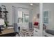 Cozy bedroom with a bright window, soft lighting, and calming decor, designed for relaxation and comfort at 27500 Janzen Ct, Englewood, FL 34223