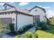 Charming single-story home featuring a tile roof, manicured landscaping, and an inviting covered entrance at 27500 Janzen Ct, Englewood, FL 34223
