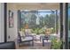 A lovely screened patio with comfortable seating and a table perfect for outdoor relaxation and dining at 27500 Janzen Ct, Englewood, FL 34223