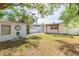 Spacious backyard featuring a wood pergola, white fencing, shed, and lush green grass at 305 W South Ave, Tampa, FL 33603