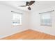 Bright bedroom features hardwood floors, two windows and a contemporary ceiling fan at 305 W South Ave, Tampa, FL 33603