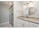 Stylish bathroom includes a glass-enclosed shower and granite-topped vanity at 3100 Magnolia Way, Punta Gorda, FL 33950